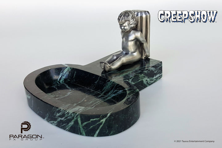 Creepshow movie prop replicas by Paragon FX Group. We are honored to have recreated George A Romero's "The Travelling Ashtray" or "Roaming Ashtray" from the beloved 1982 horror anthology, Creepshow. Manufactured from 4 pounds of solid marble, this limited edition, full-size prop replica is adorned with a pewter cherub.