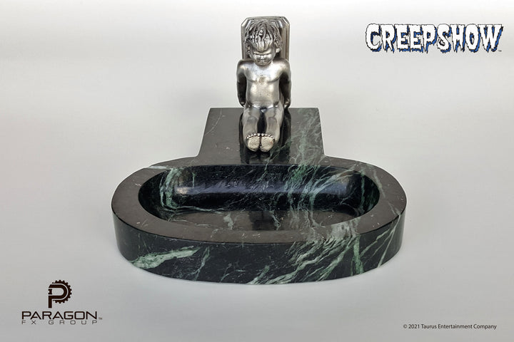 Creepshow movie prop replicas by Paragon FX Group. We are honored to have recreated George A Romero's "The Travelling Ashtray" or "Roaming Ashtray" from the beloved 1982 horror anthology, Creepshow. Manufactured from 4 pounds of solid marble, this limited edition, full-size prop replica is adorned with a pewter cherub.